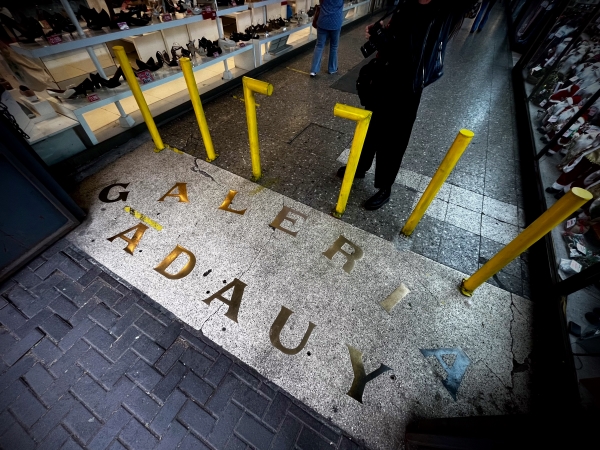 Gold letters in stone on the ground at the entrance to the covered Galeria Adauy market in Concepcion, Chile.