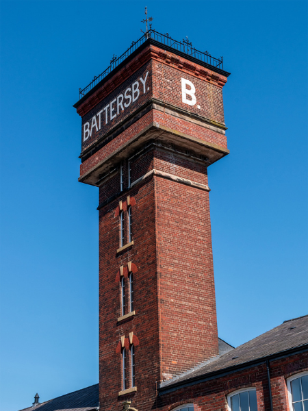 The former Battersby Factory, a red brick tower with white painted text "BATTERSBY." and "B."