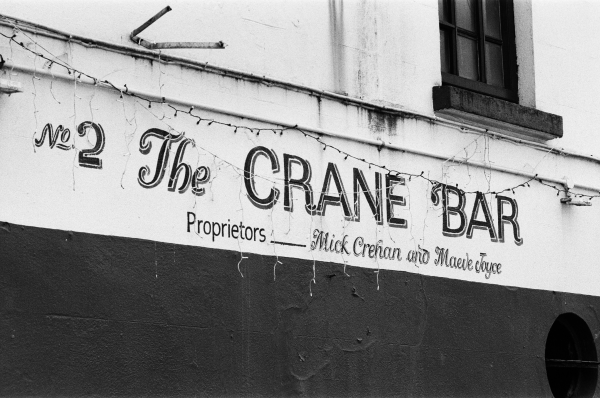Black and white photo of The Crane Bar painted sign. Photo by Jake Murtaugh.