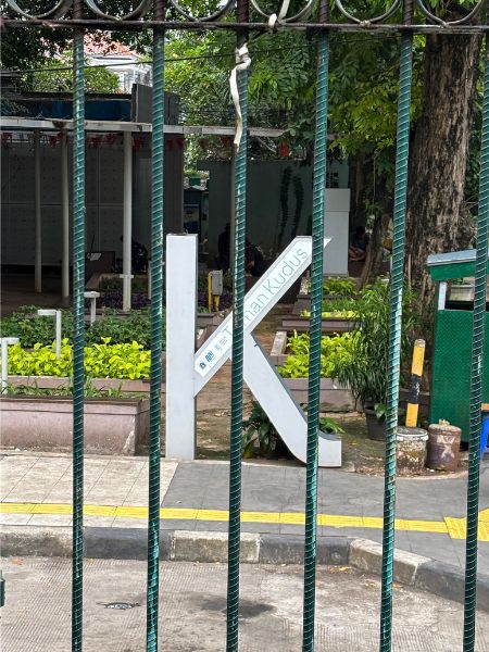 A sculpture of the letter K in the Jakarta Sans typeface stands in a public space in Jakarta.