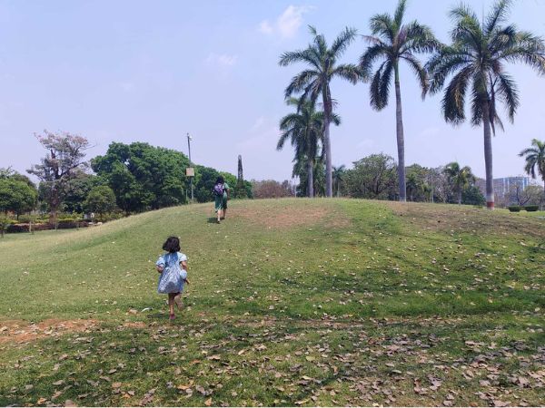 Sneha and her daughter exploring a local park.