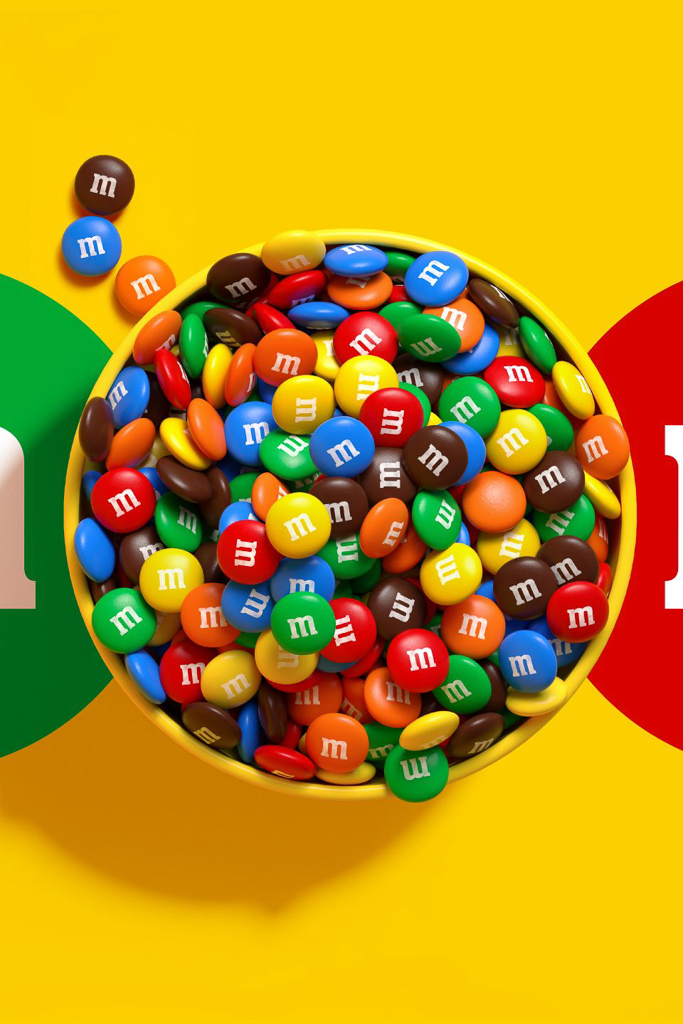 A bowl full of colorful M&M's candies on a yellow background, with large green and red lettermarks on either side.