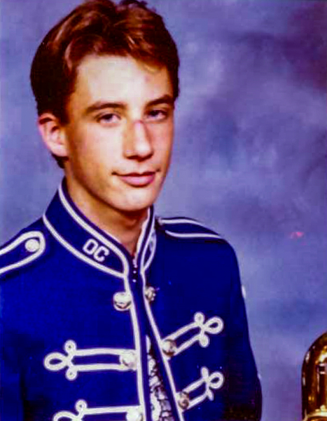 Jan in his high school marching band uniform (dark blue and silver accents), along with his mellophone.