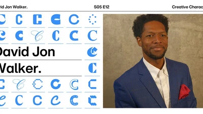 Headshot of David Jon Walker in a blue suit coat with red handkerchief 