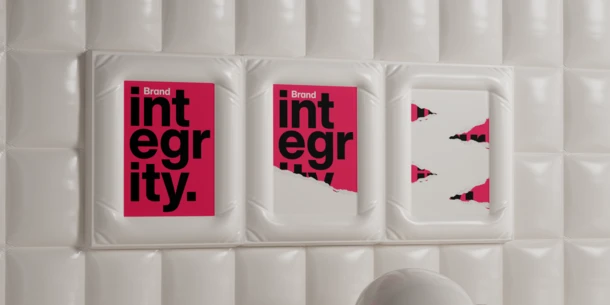 Image of three posters on a white inflated background. Poster is Tokyo Red, with "integrity." in large black text. The poster is ripped, degrading as you move from left to right.