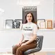 Portrait of Marie in front of framed typeface art and a neon Monotype Logo Portrait of Marie in front of framed typeface art and a neon Monotype Logo