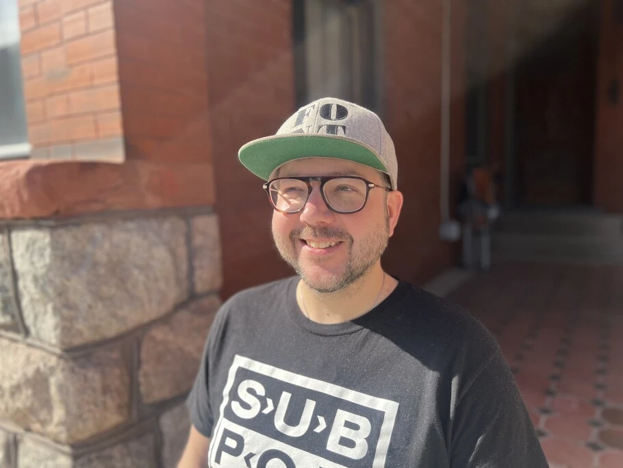 Portrait of Phil Carey-Bergren standing outside in the sun.