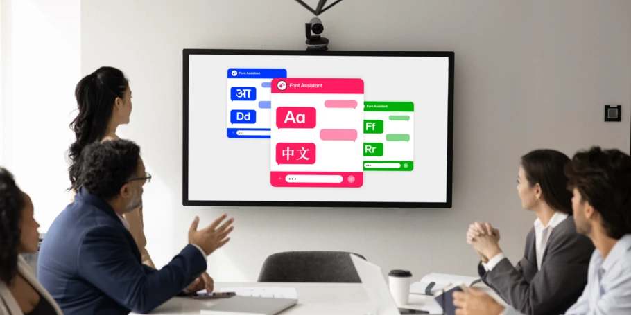 People in a boardroom discuss while looking at a large screen displaying type in varying scripts, including Latin and Chinese, in blue, red, and green.